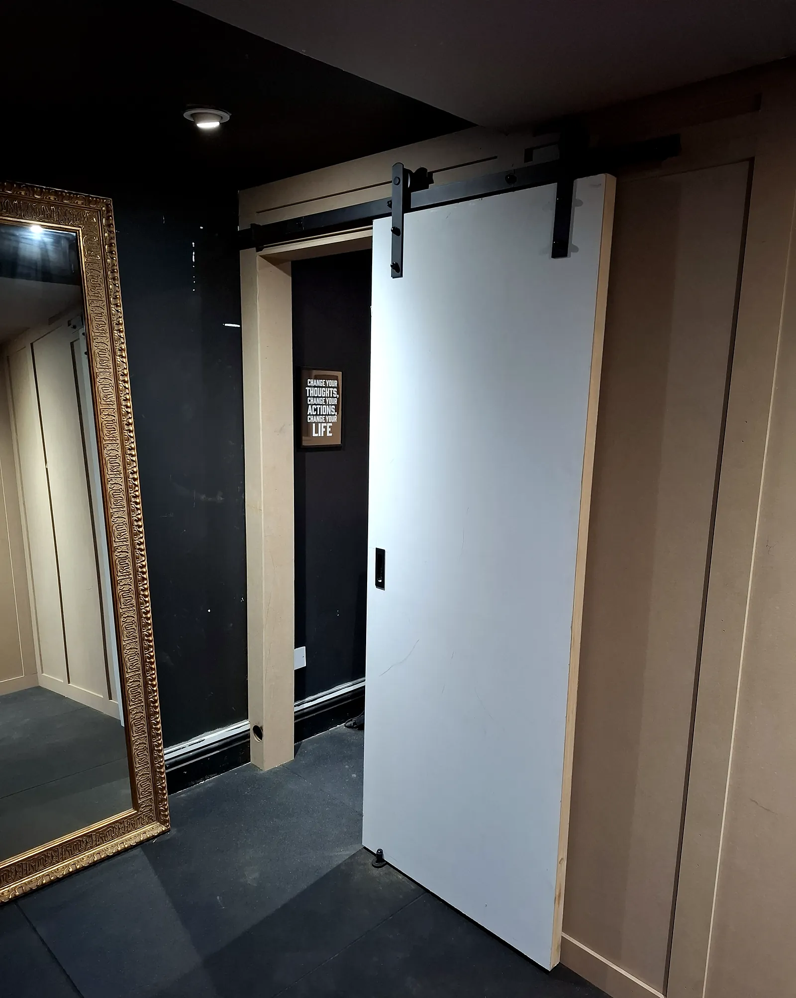 Sliding barn door and wall panelling fitted in a home gym