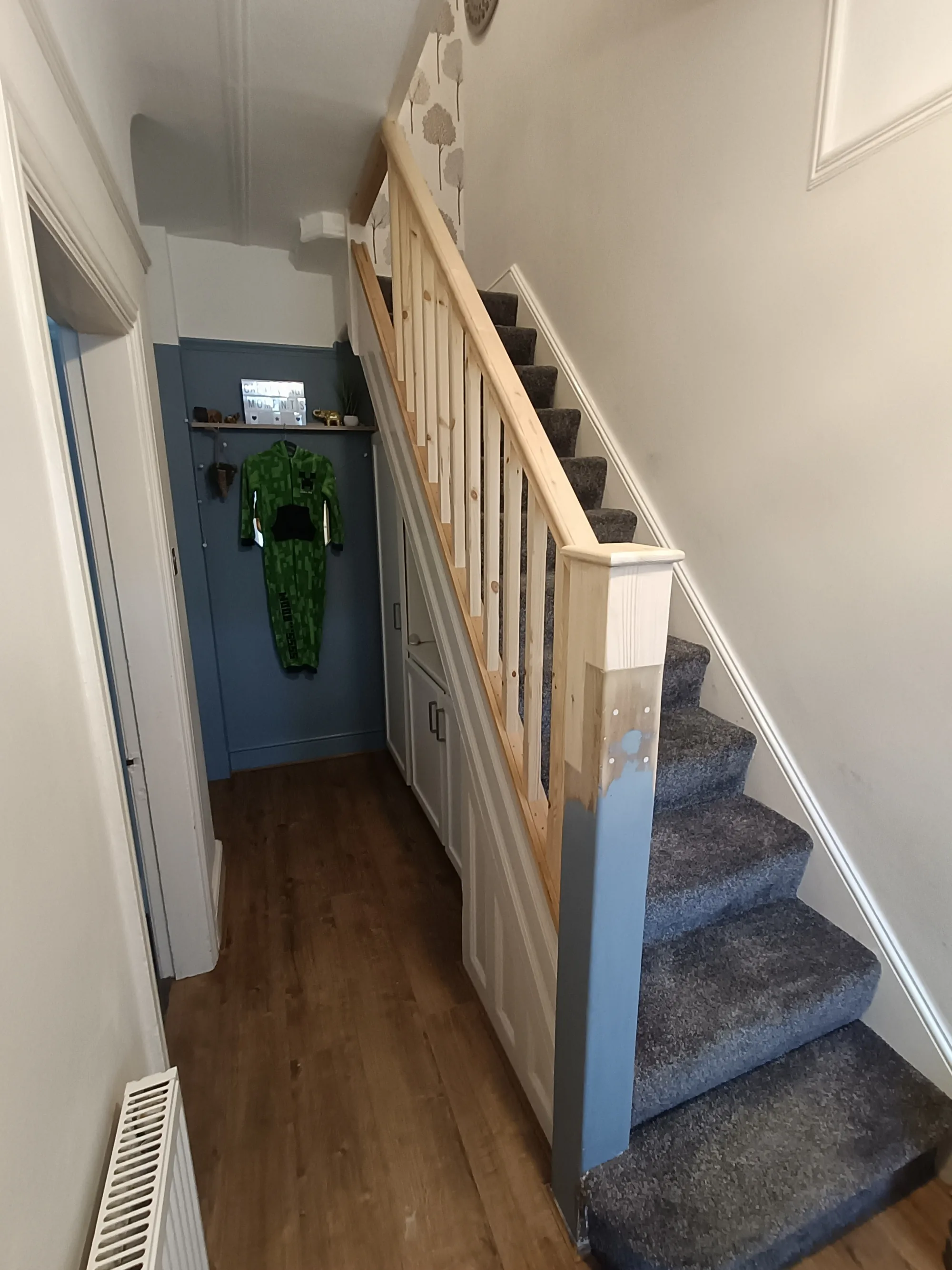 Hallway staircase with a new handrail, spindles and newel post